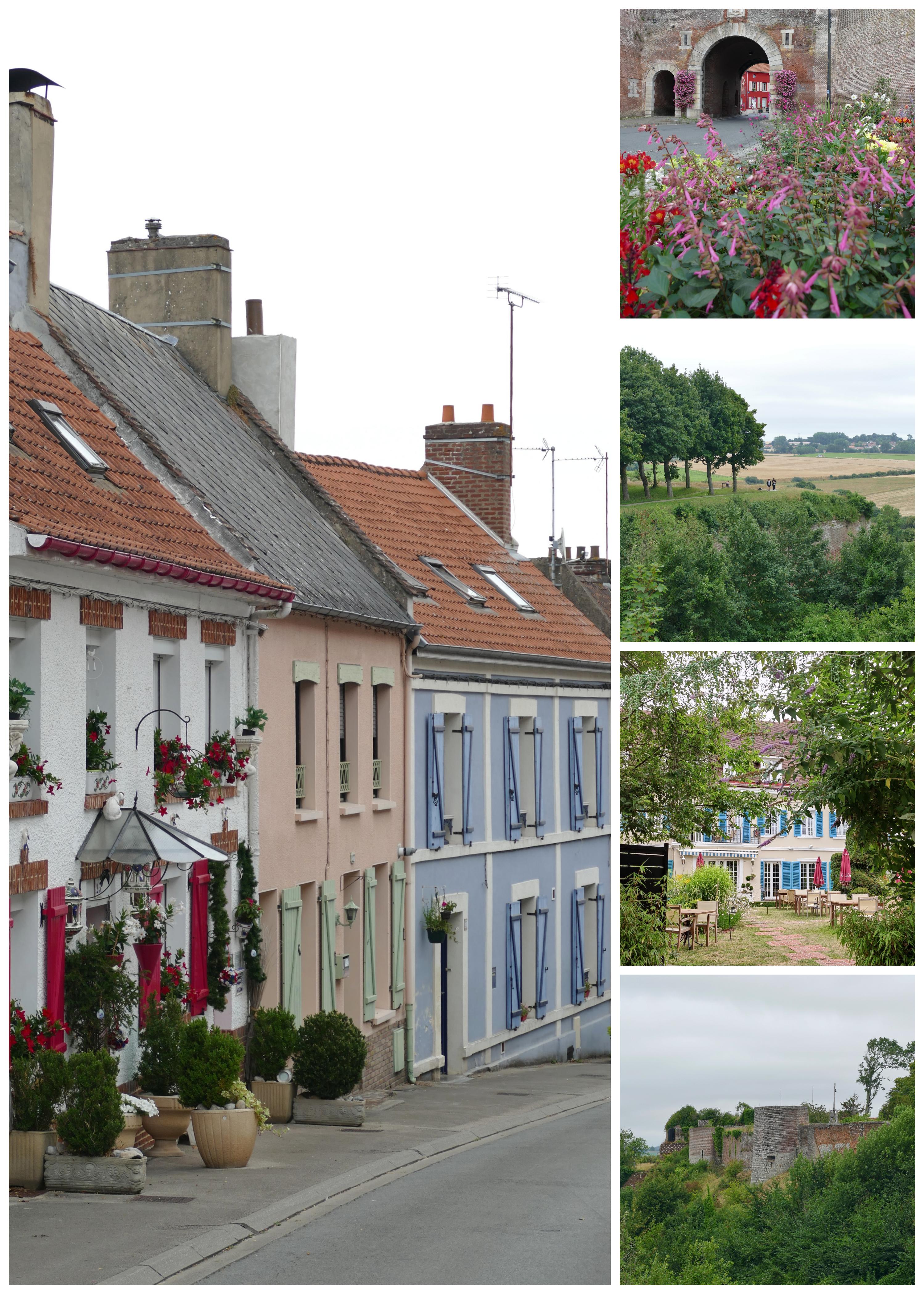 colourful houses and rural scenes french village with views of castle remains and rampart walk leading into green countryside